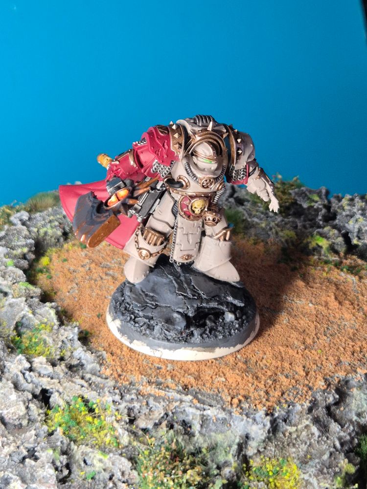 Two pictures of a Death Guard Centurion Terminator, a Horus Heresy miniature in beige and red. 
