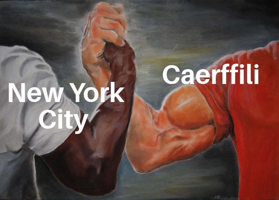 The handshake meme from Predator, with the words New York City and Caerffili. 