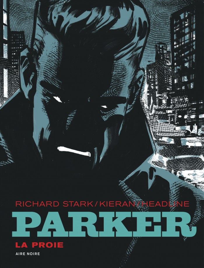 Cover for Parker 1969: La Proie featuring a close-up head & upper torso shot of a scowling man shrouded in darkness, collar turned upwards, as he walks down a busy urban street.