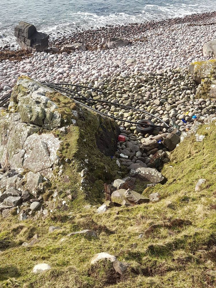 A 70 metre coil of salmon farm feed pipe washed up on Raffin beach, Assynt