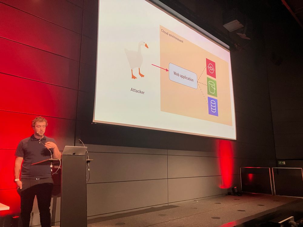 Christophe presenting with a slide showing a goose attacking cloud based systems