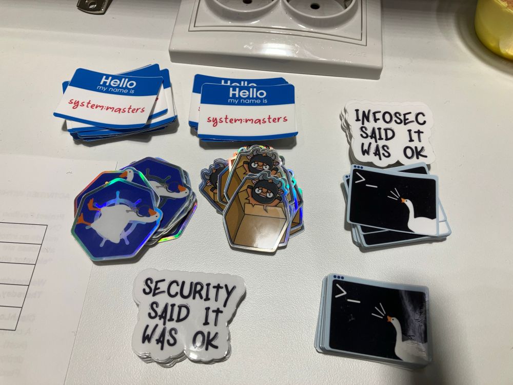 Piles of kubernetes security stickers on a table