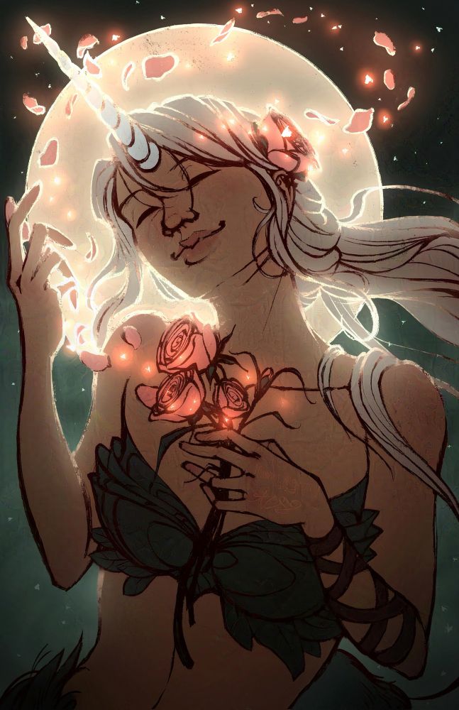 A woman with a unicorn horn and long, white hair smiles wistfully. She holds a handful of pink roses whose petals have whipped into the air above her and sparkle with magic. A leafy bra covering hides her chest and a leather strap adorns the arm holding the flowers against her. She’s backed by the light of a full moon.