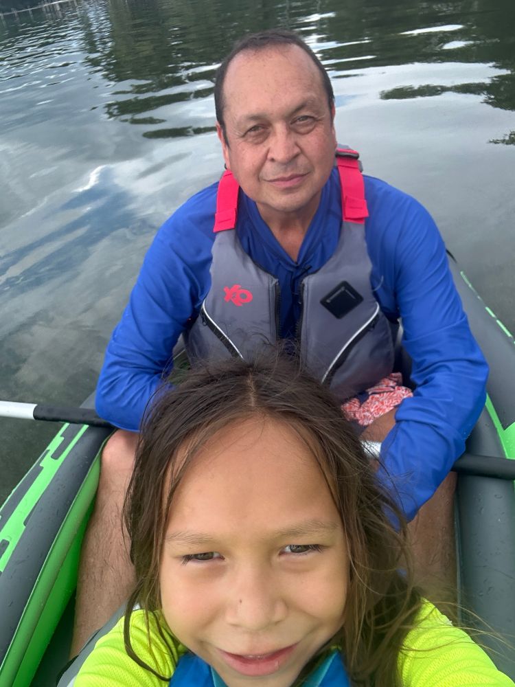 Man and young son sitting in kayak 