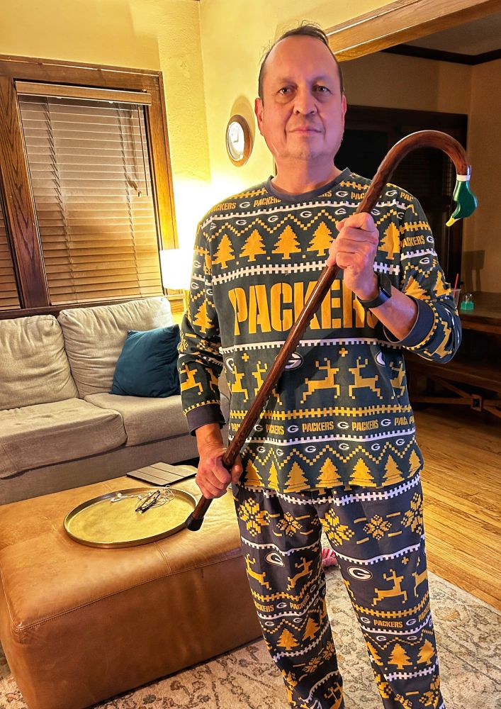 Man holding wooden cane with top carved to resemble duck head