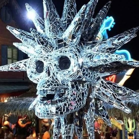 A giant disco ball in the shape of a skull with spikes.