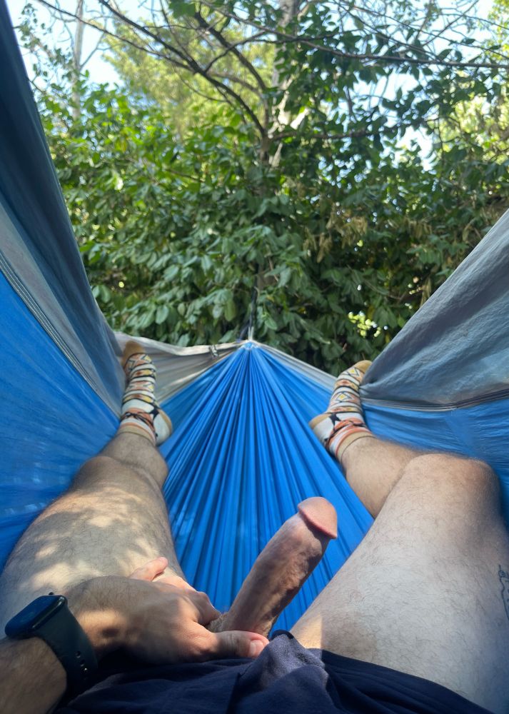 hunter with his cock out in a blue hammock