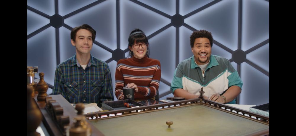 shot of zac, emily, and lou smiling. zac is smiling like :] while emily is grinning and trying not to break, and lou is half a second from losing it completely