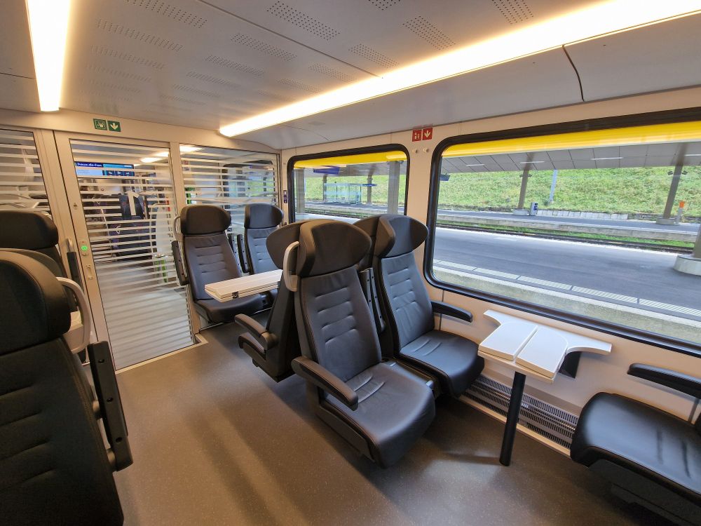 1st class cabin in a TransN ABe 4/8. The 1st class features 11 black leather seats