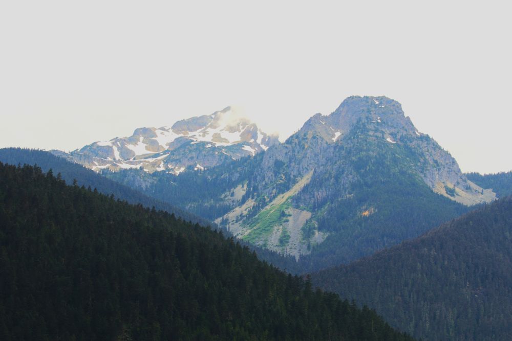 A mountain peak with snow and scree slopes.