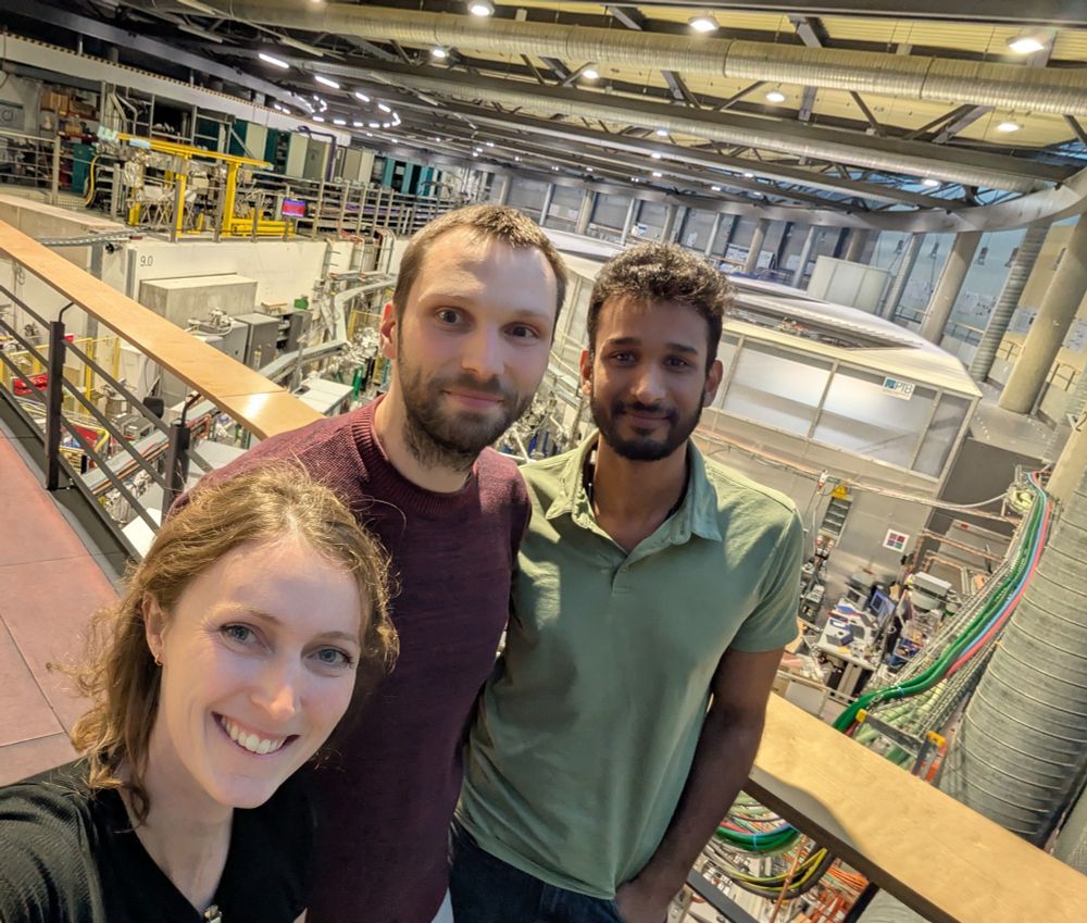 Three members of the group stand on a bridge over the ring at the BESSY II synchrotron 