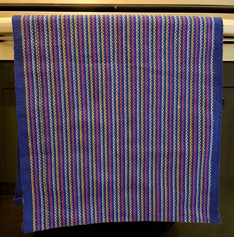 Dark blue, gold, pink and light blue striped hand-woven tea towel.