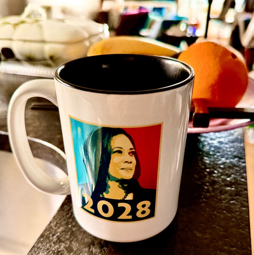 A mug has a photo (in the style of the Obama "Hope poster") of Kamala Harris with 2028 across the bottom