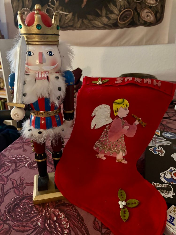 A big nutcracker and a felt stocking with an angel and the name Sarah on it