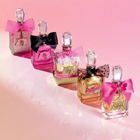 Nostalgic late 2000s/early 2010s perfume bottles by juicy couture with flashy glittery pink bows on them and their classic logo. Think Paris Hilton vibes! They smelled AMAZING!!