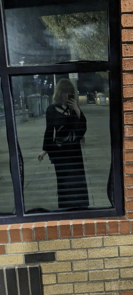 Reflection off a window of a woman wearing a black goth dress. She is incredibly hot and amazing (⁠ ⁠´⁠◡⁠‿⁠ゝ⁠◡⁠`⁠)