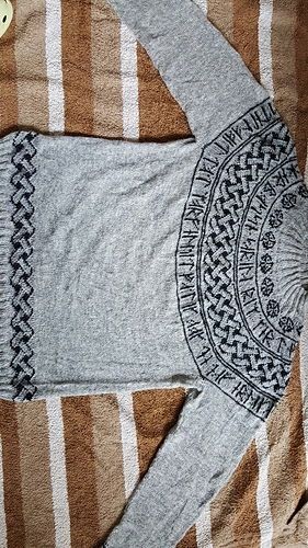 A grey sweater with Rune text which says the name of my husband and that he likes his old Triumph car