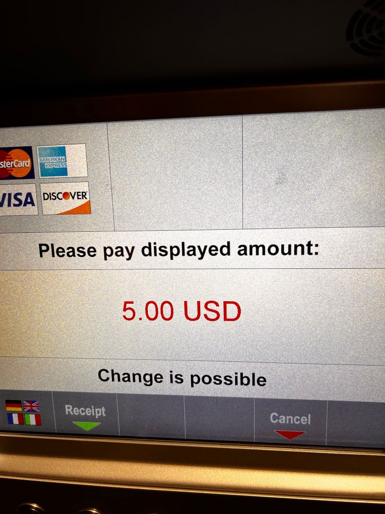 Photo of the screen of a parking validation machine that says "please pay displayed amount: five dollars", and underneath that, "change is possible."