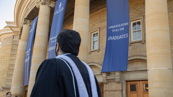 Image shows a graduate outside Convocation Hall