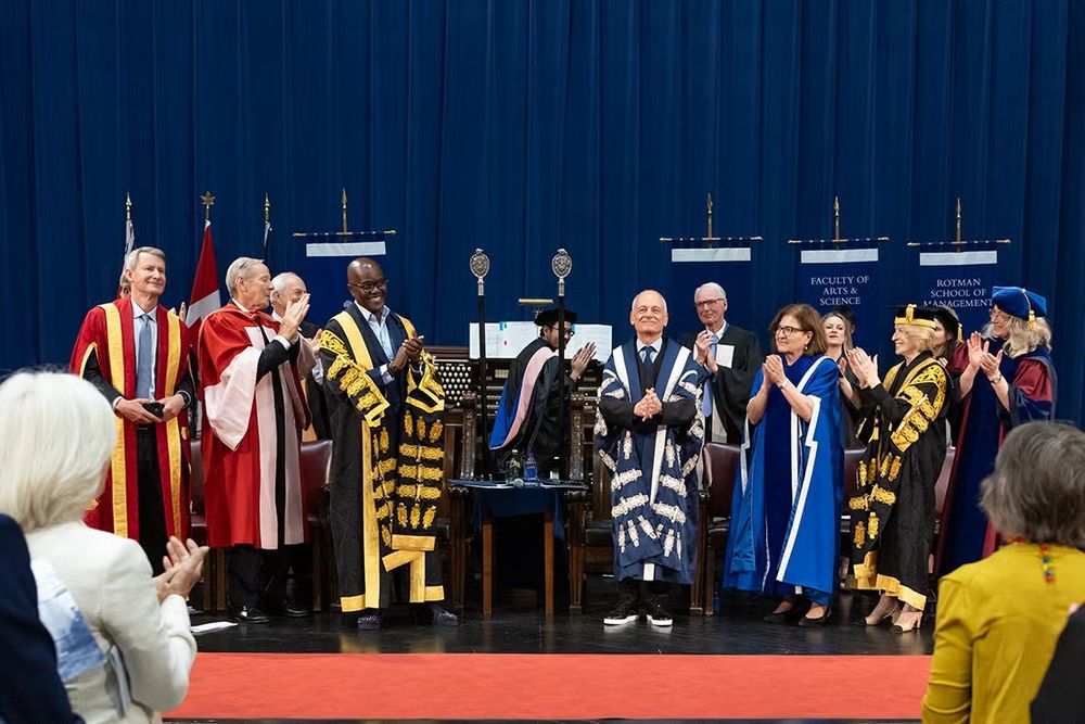 U of T President Meric Gertler, wearing his blue-and-white presidential robes, receives a standing ovation during his final convocation ceremony on June 20