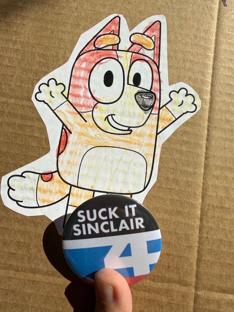 My bingo protest sign and a "Suck it Sinclair" button.