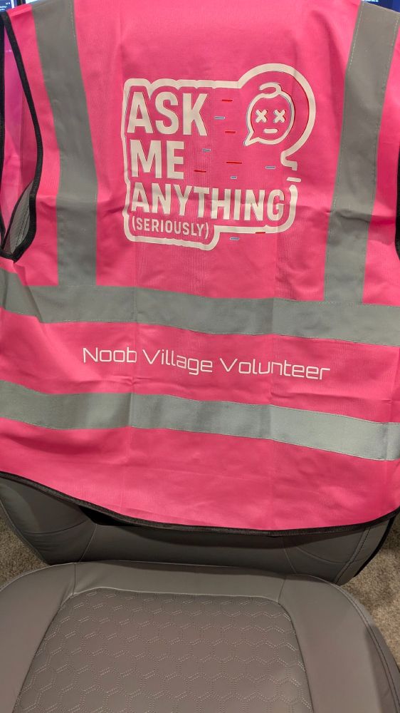 Pink high-vis noobvillage volunteer jacket