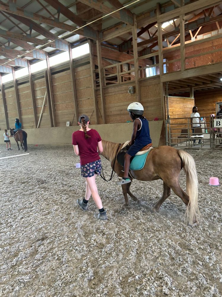 Showing student on Scotti walking through an obstacle course built by the kids. 