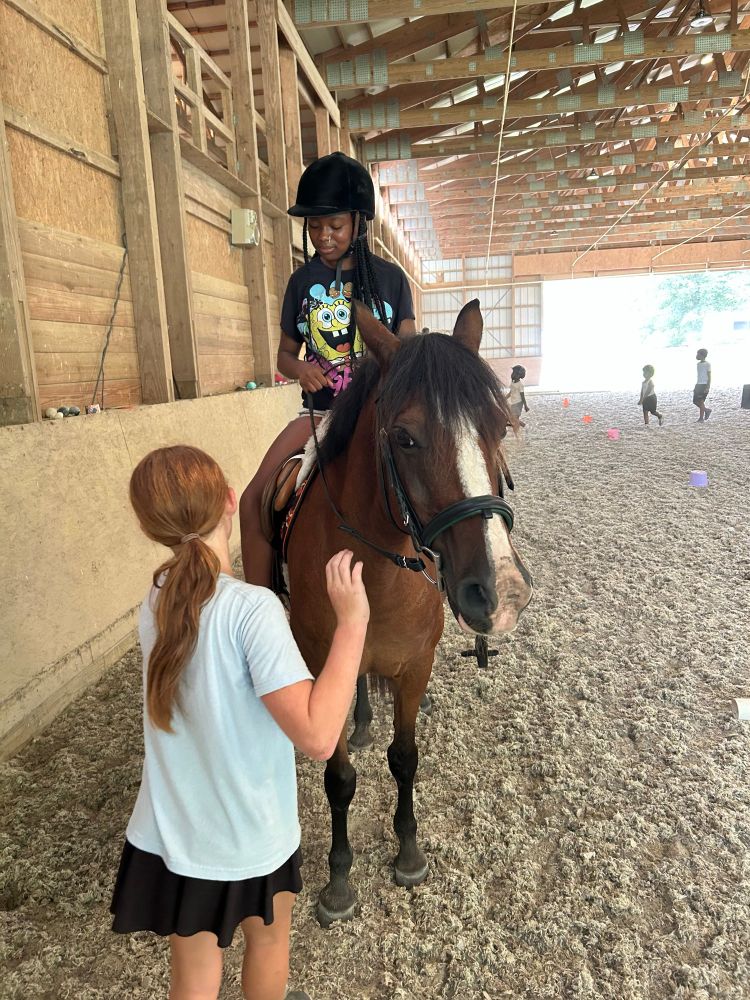 Young students working together with Wendy. Steering and stopping is always on the agenda to teach first. 
