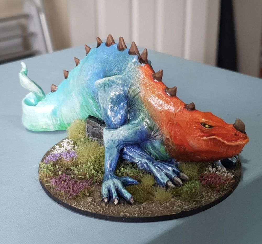 Big wyrm coloured orange to blue to light teal with brown spines