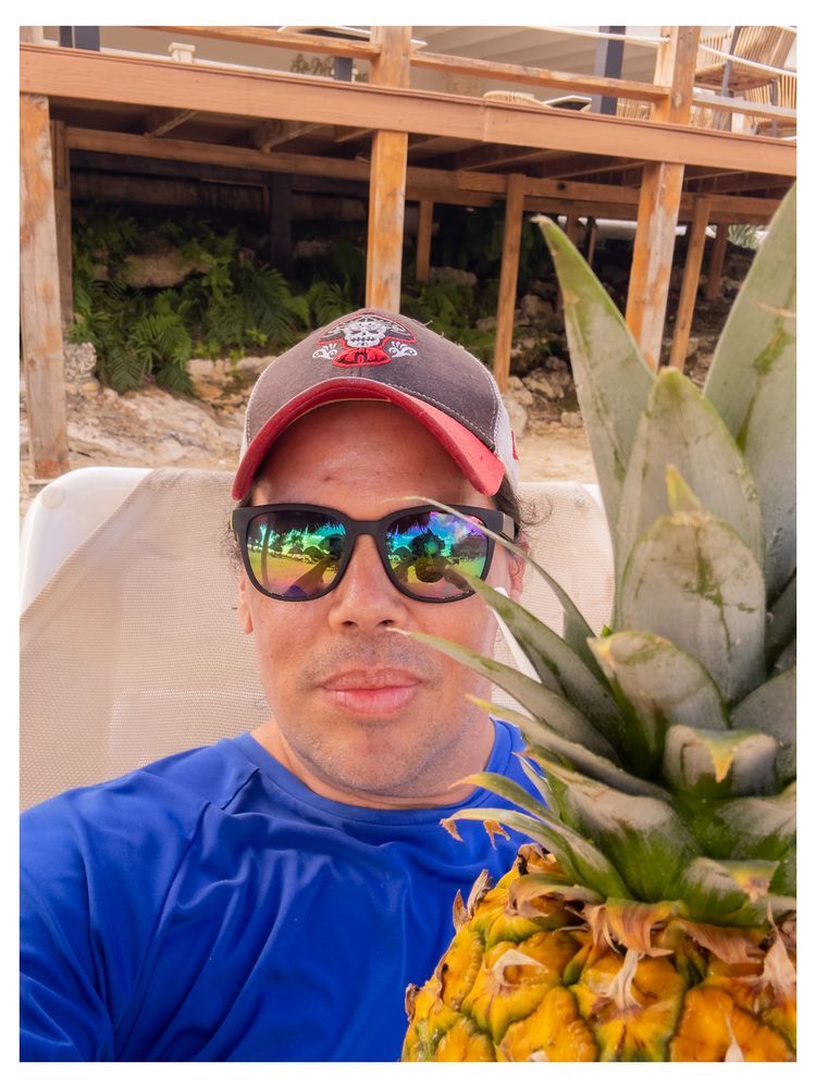 A person drinking a pineapple drink 