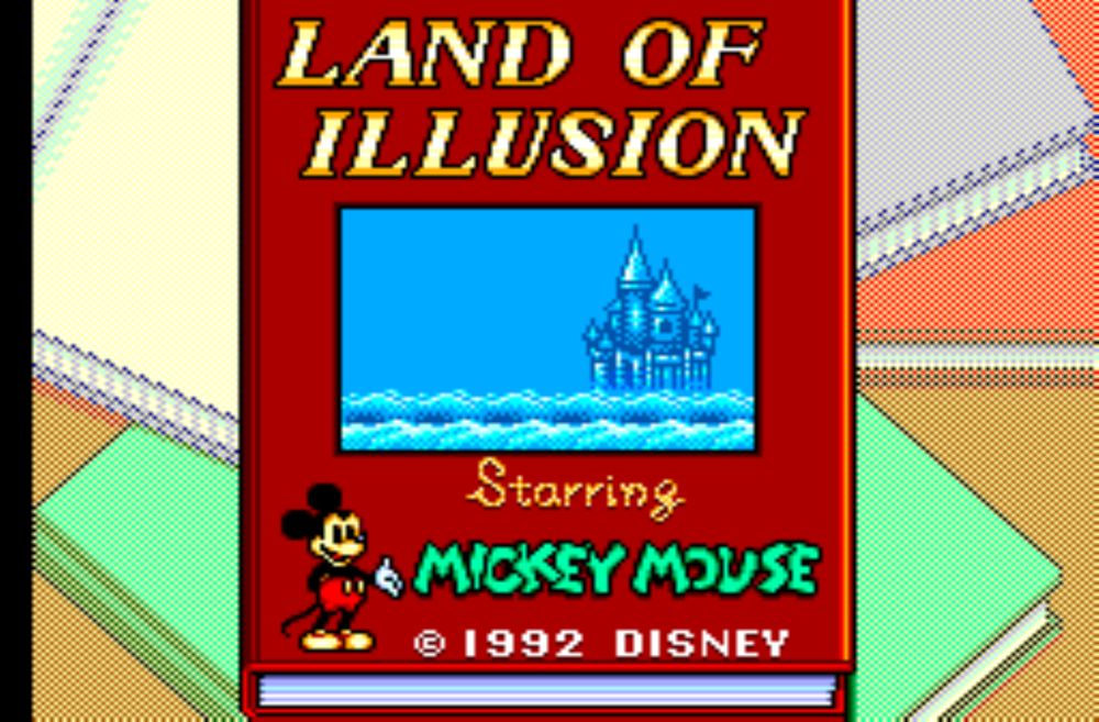 The title screen for Land of Illusion starring Mickey Mouse on the Sega Master System. A red book with he game's title and an image of a castle floating on a sea of clouds, is shown on a pile of note books.