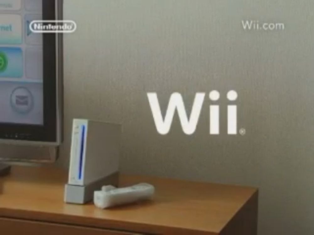 A Wii showned next to the Wii logo, placed in a typical Japanese room