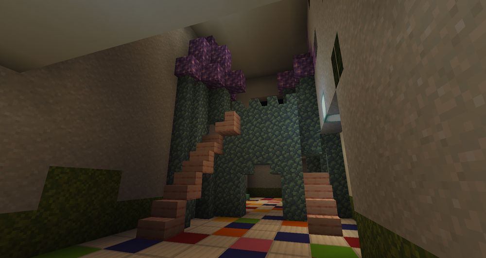 A minecraft screenshot from my liminal build. This scene is a colorful dreamcore castle interior, looking sort of like a play place that was built in an otherwise barren, cavernous room. The floor is tiled with white and rainbow tiles. The castle has purple amethyst roof parts, and prismarine blue walls, with pink stairs leading up to the top.