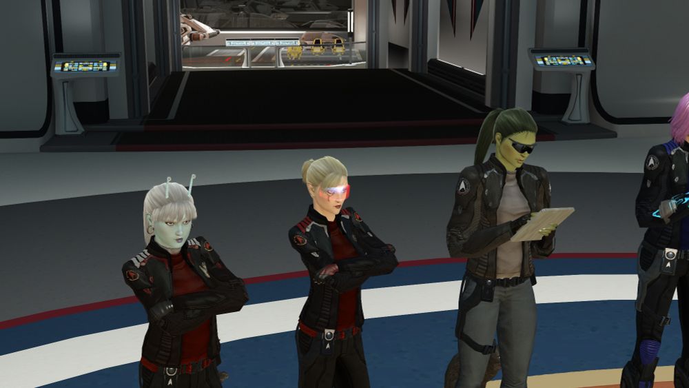 An Andorian, a Romulan and an Orion in Starfleet Excursion jackets, hanging out and power posing on Earth Space Dock.