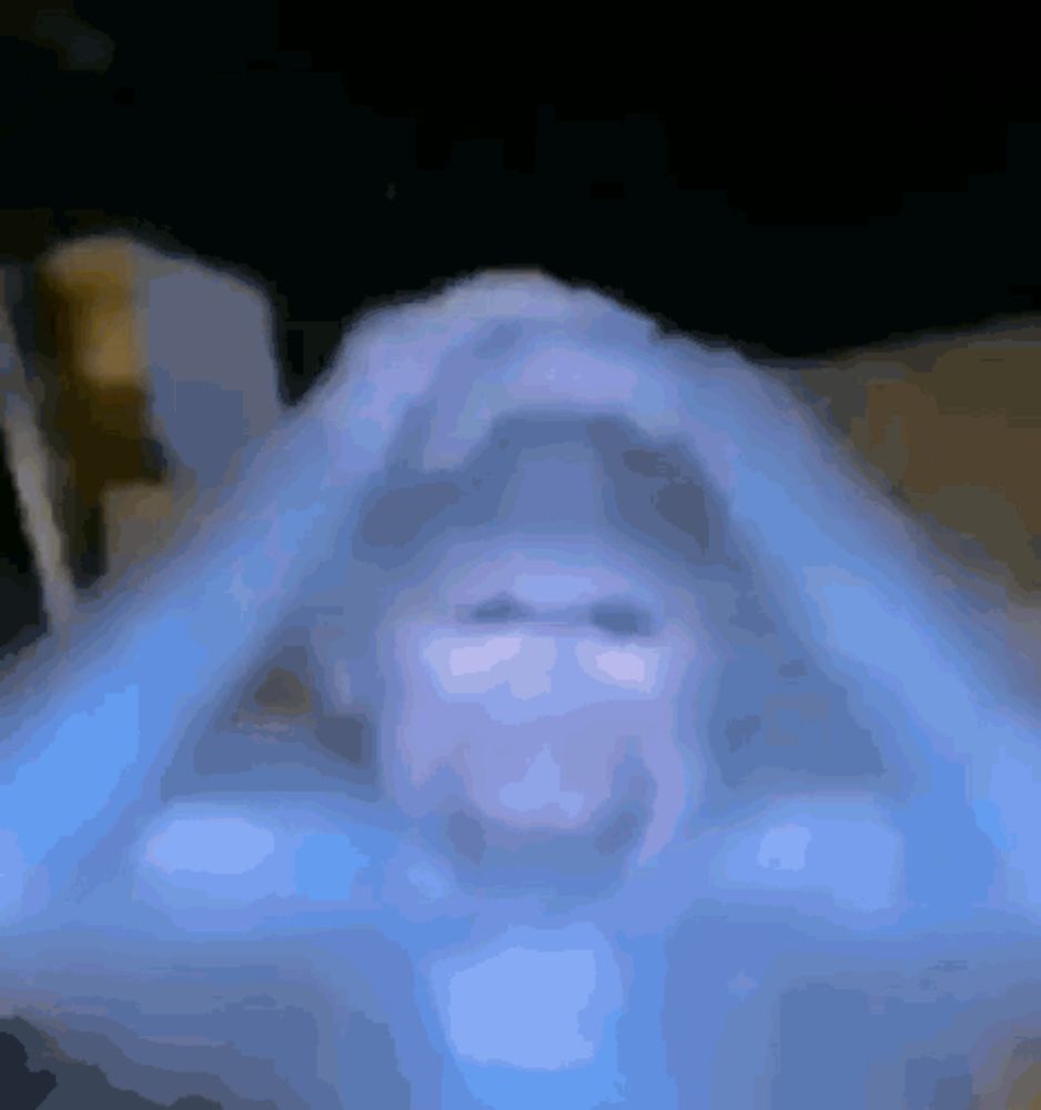 a blurred image of a person 's face with a blue background