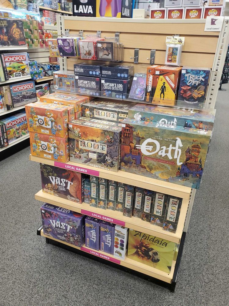 An endcap at Games by James featuring locally designed games like ours! Oath, Root, For, and more.