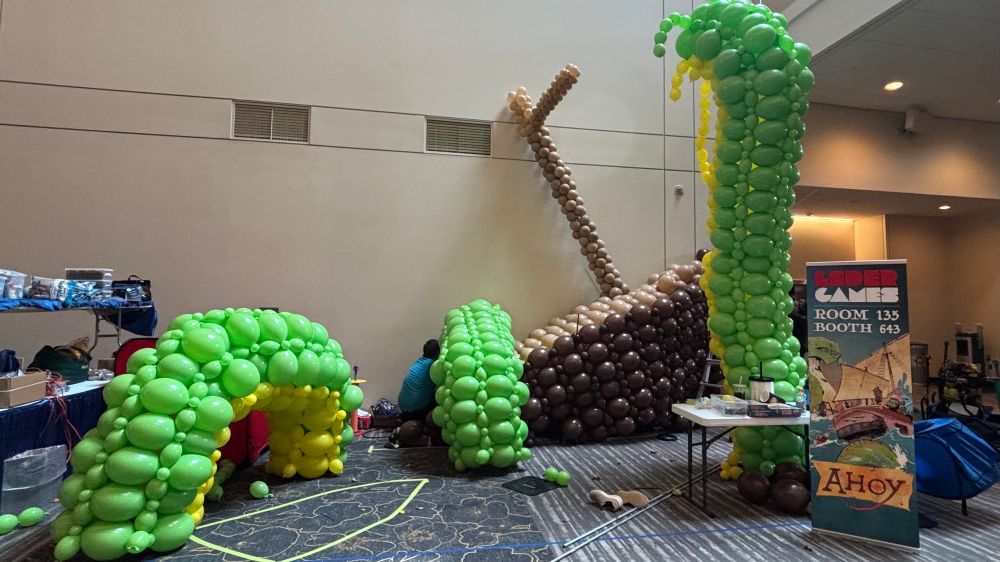 A balloon sculpture in progress, with maybe a ship and a green sea monster??
