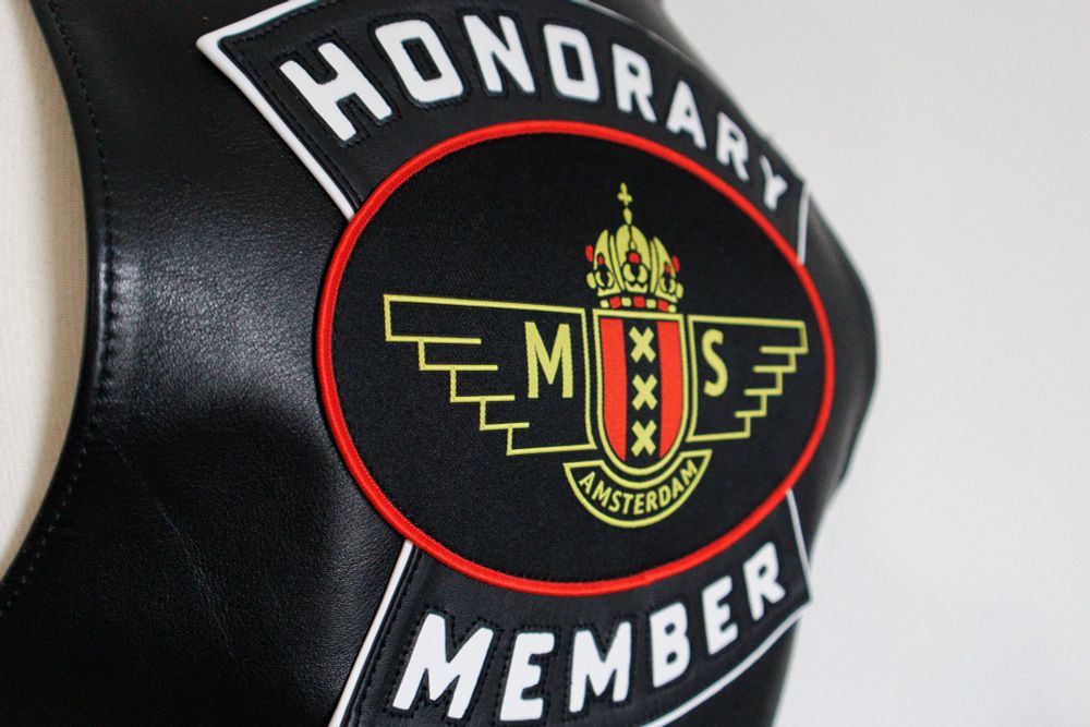 Close up of the MSA Honorary Member patch. The logo itself is woven with the word Honorary and Member in leather surrounding it with a white border.