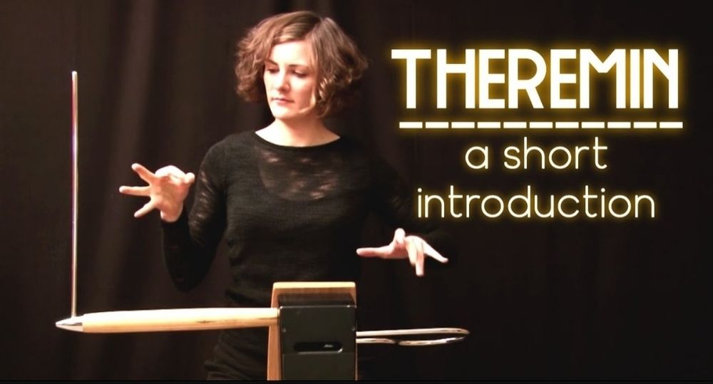 Thumbnail from a YouTube video about the instrument called a Theramin.  The thumbnail shows a woman with outstretched hands playing the theramin.