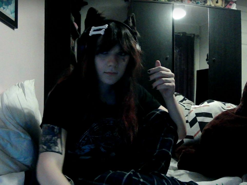 Webcam pic of a girl with dog ears and dog bone hair clips