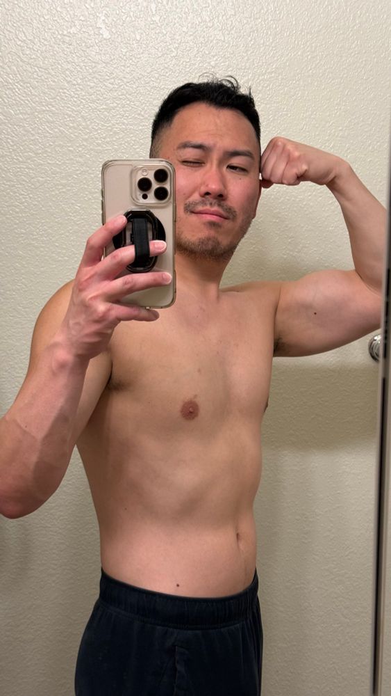 Jon Jeo posing like a gym douche