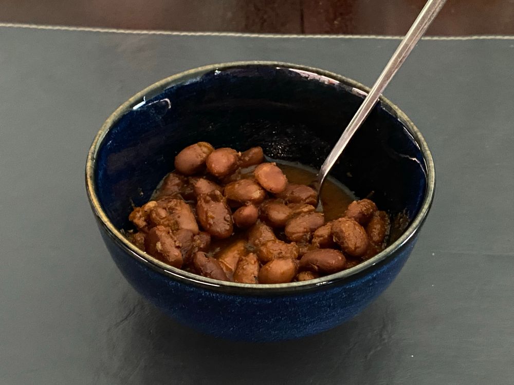 lil bowl of pinto beans in a red broth