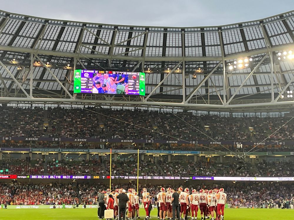 The Iowa State football team on the field at Aviva Stadium in Dublin, playing against Kansas State