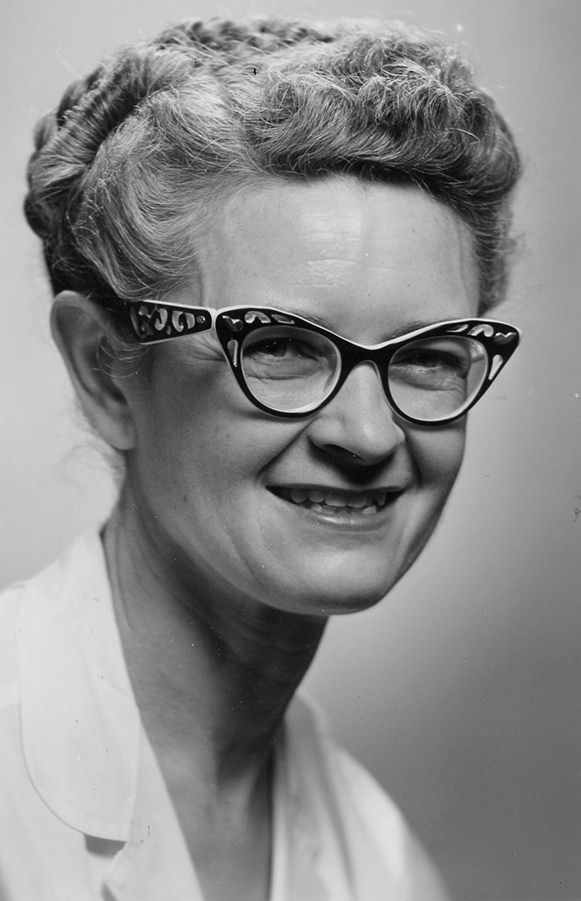 A black and white portrait of Dr. Marvis Richardson, the first person in the department to earn an NSF fellowship. She is wearing fabulous cat-eye glasses and has her hair in an updo. 
