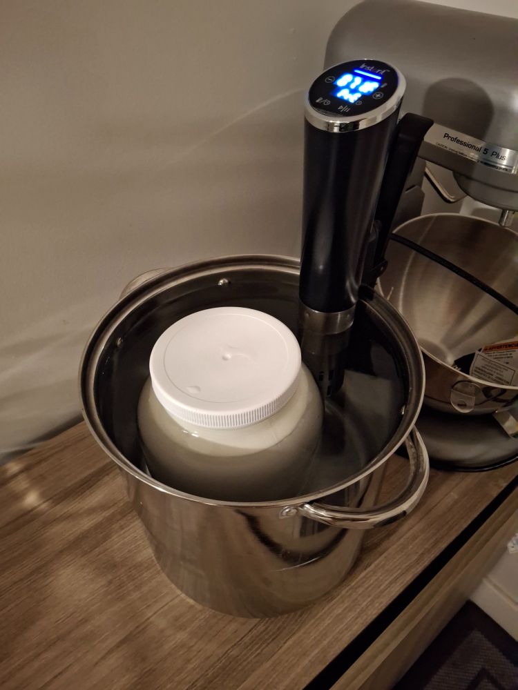 A gallon jar of soon-to-be yogurt in a soon-to-be-100°F sous vide bath in a giant soup pot. 