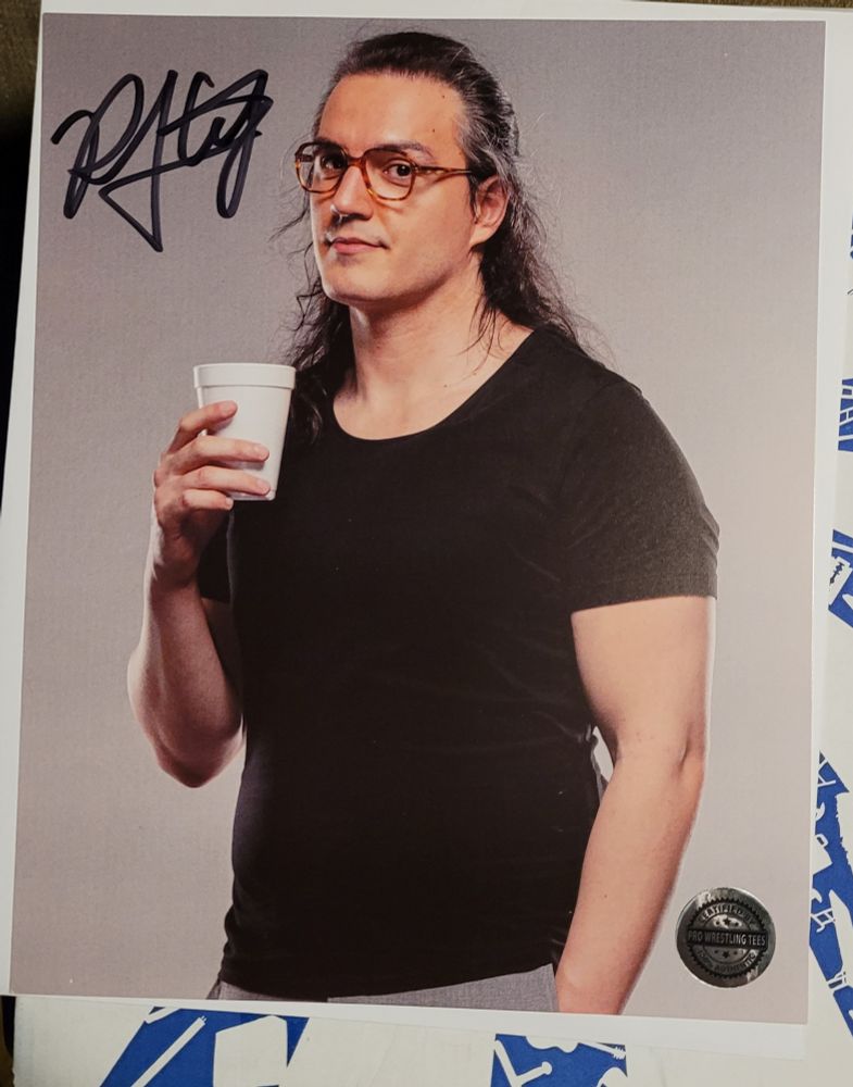 RJ City holding white cup while looking at the photographer 