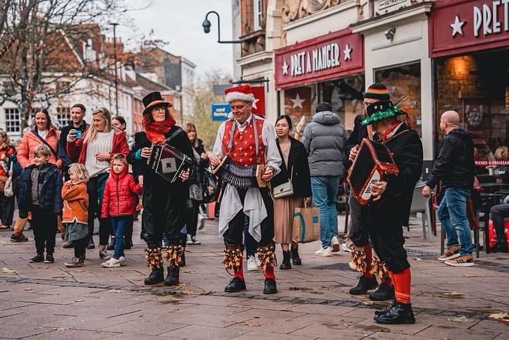 Musicians playing for Morris dancing in festive attire