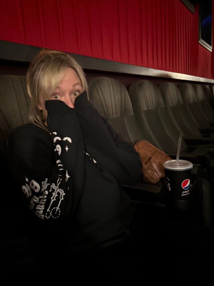 Jackie (Super Enthused) in the movie theatre after seeing Wicked, looking like she loved the movie! 