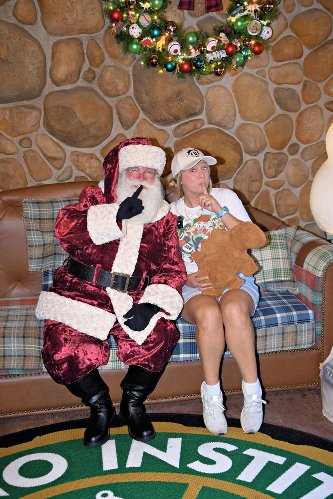 Santa Claus with Jackie super enthused holding a dinosaur nugget at Disney’s animal kingdom 
