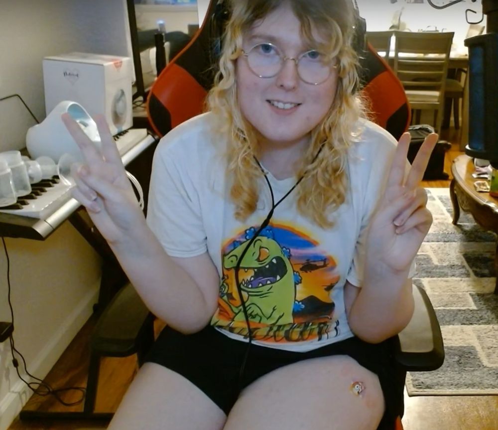 picture of me doing double peace signs with a bandaid now on the injection site